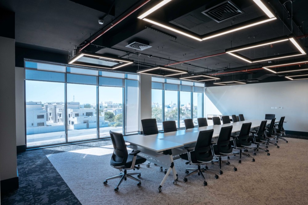Boardroom under a floating linear light frame