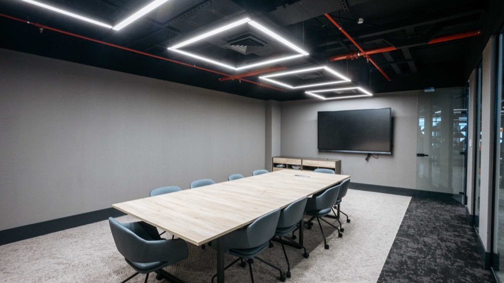 Meeting room — exposed services, linear lighting