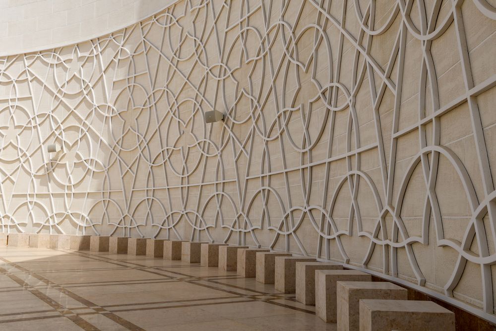 Relief wall and stone seat plinths in raking light