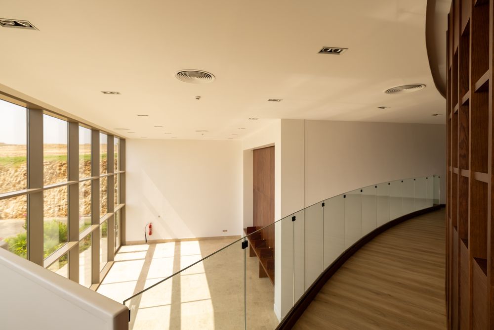 Mezzanine walkway, glass balustrade and timber handrail