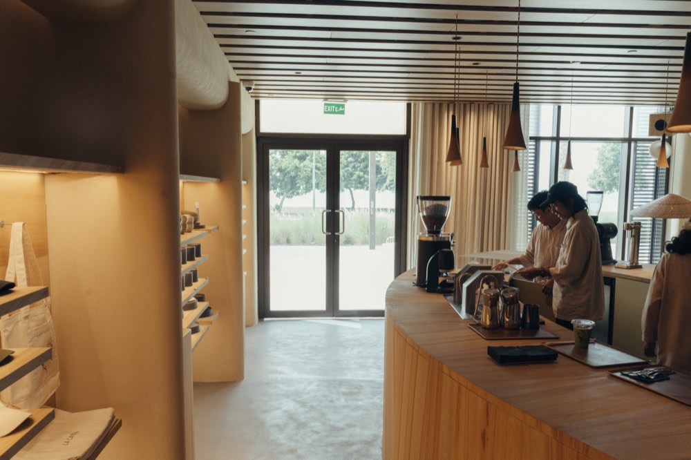Curved solid-oak service counter under a slatted timber ceiling