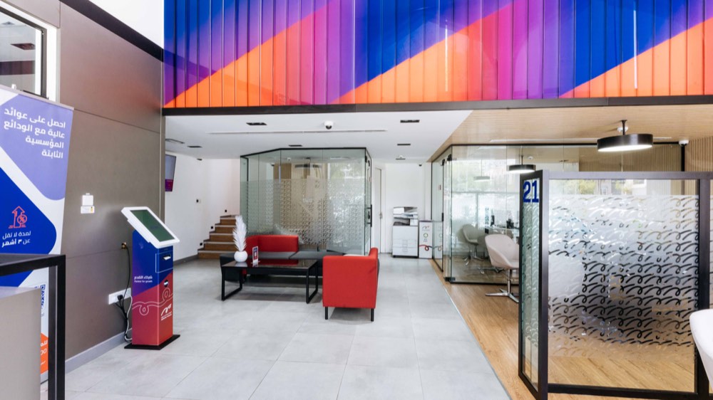 Double-height banking hall with colour-blade feature ceiling