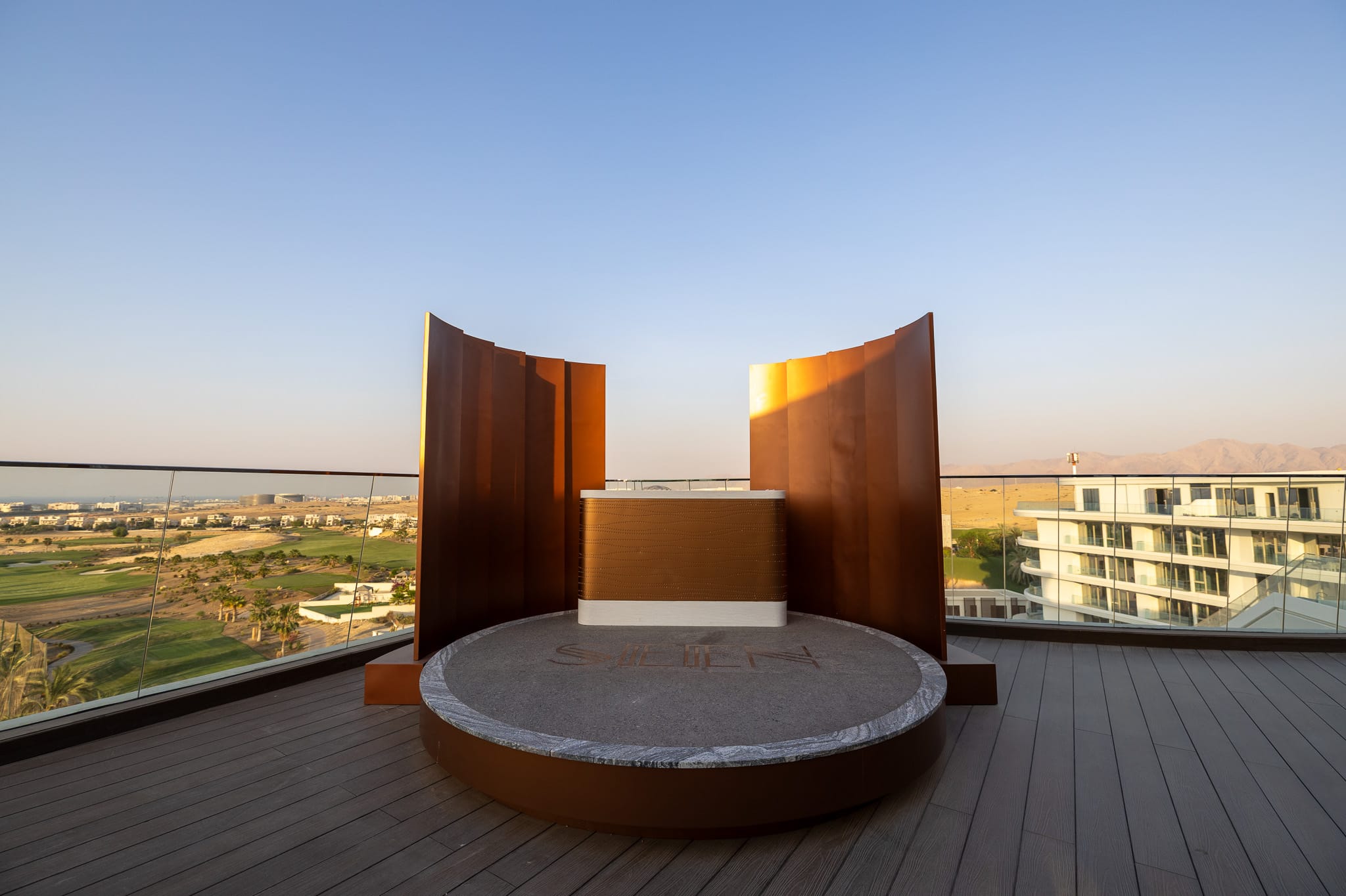 Corten-steel signature feature, framing the golf-course view