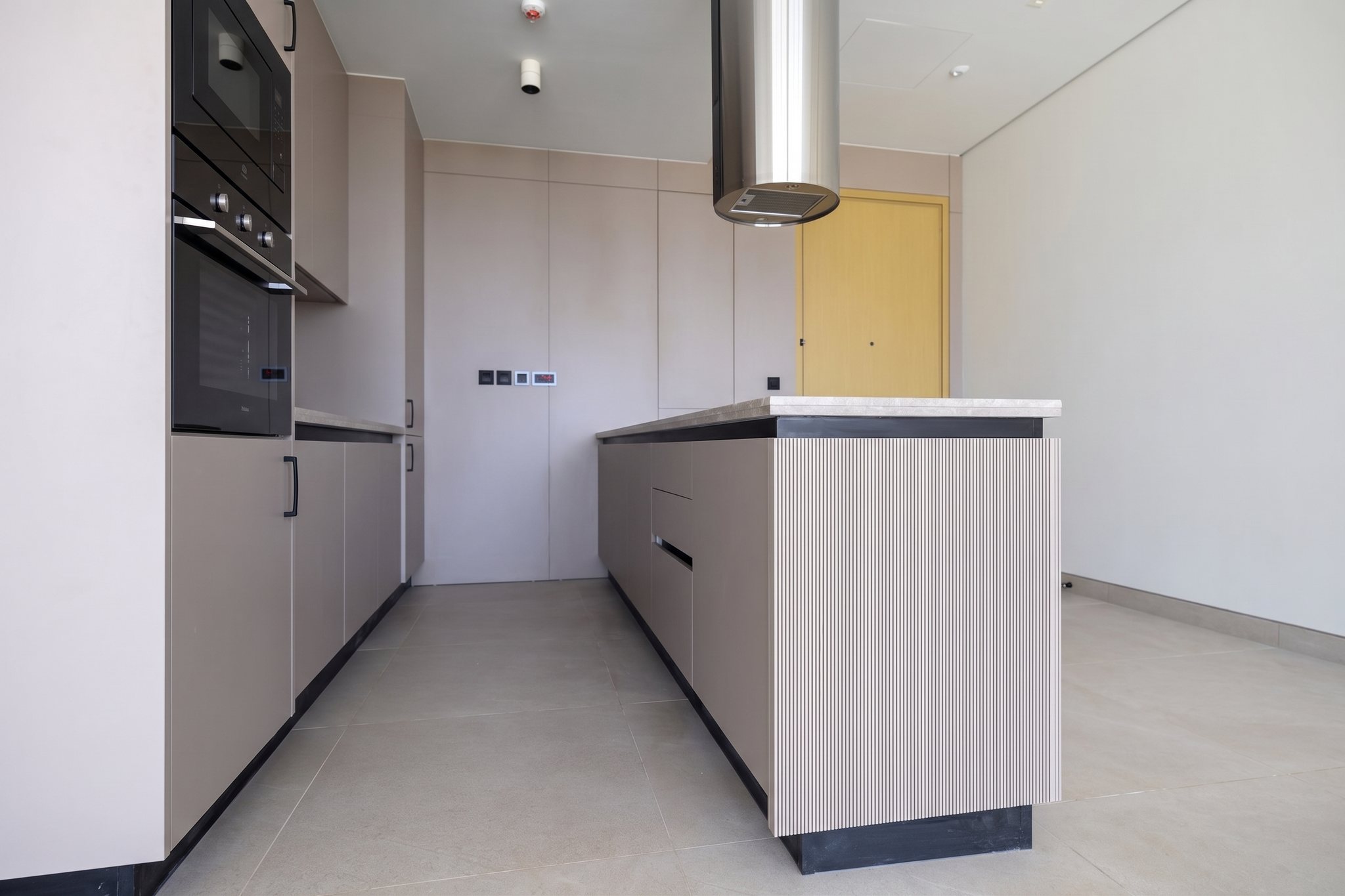 Anatomy of a statement kitchen: stone, fluted timber & hidden engineering