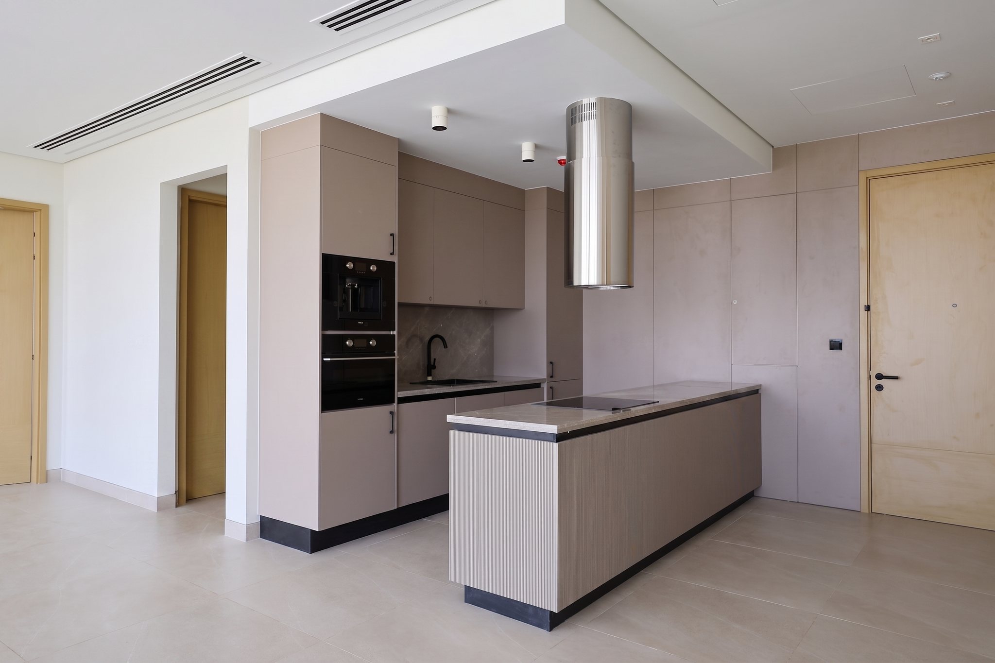 Full kitchen — taupe cabinetry & sculptural extractor